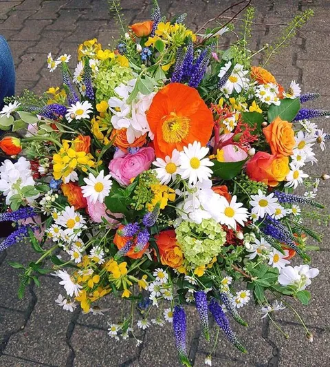 Frühlingsstrauß mit orangem Islandmohn, Ranunkeln und Veronica